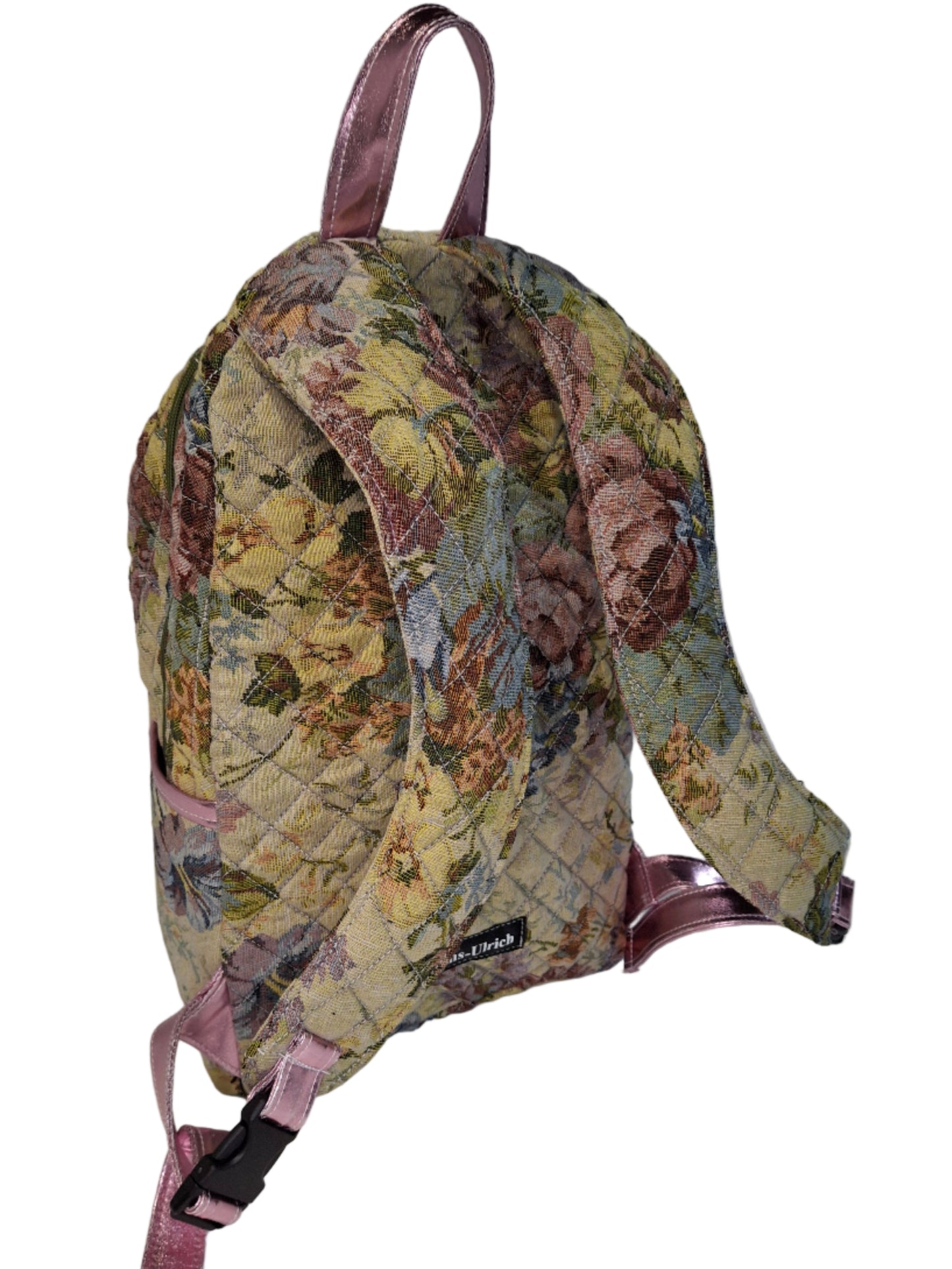 Floral-patterned backpack with pink straps on a white background
