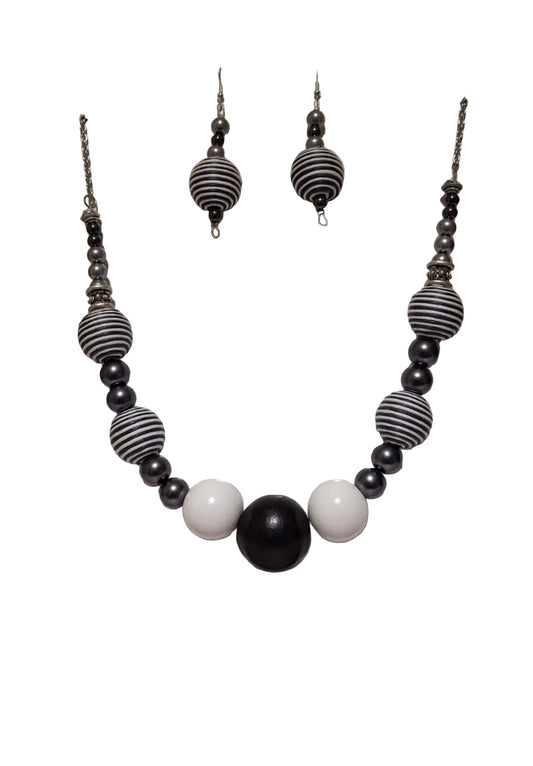 Black and white beaded necklace and earrings on a white background
